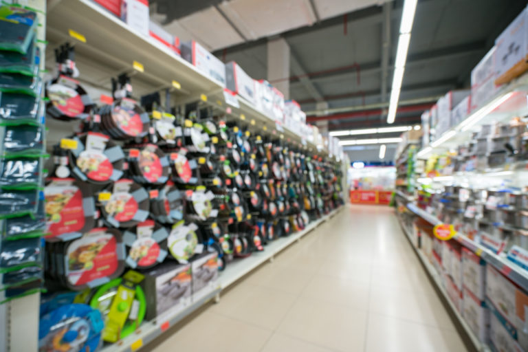 The aisle of a hardware store with a range of outdoor products.